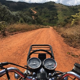 Close-up of a motorcycle handlebar with the Blue Ridge Mountains stretching out ahead.