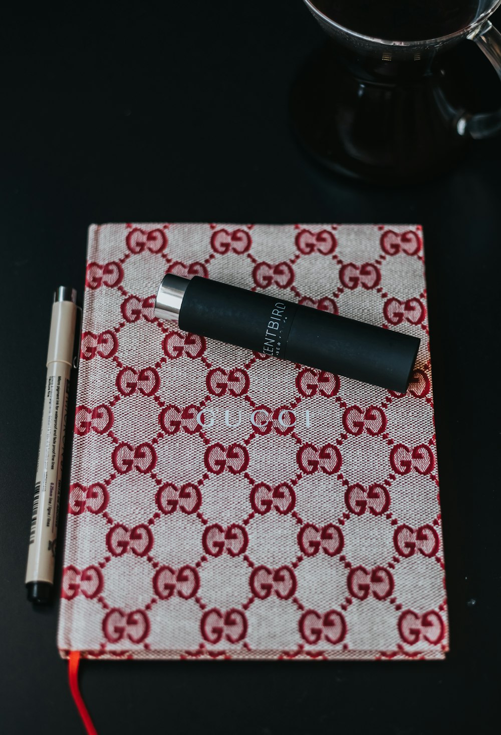 red and gray Gucci planner