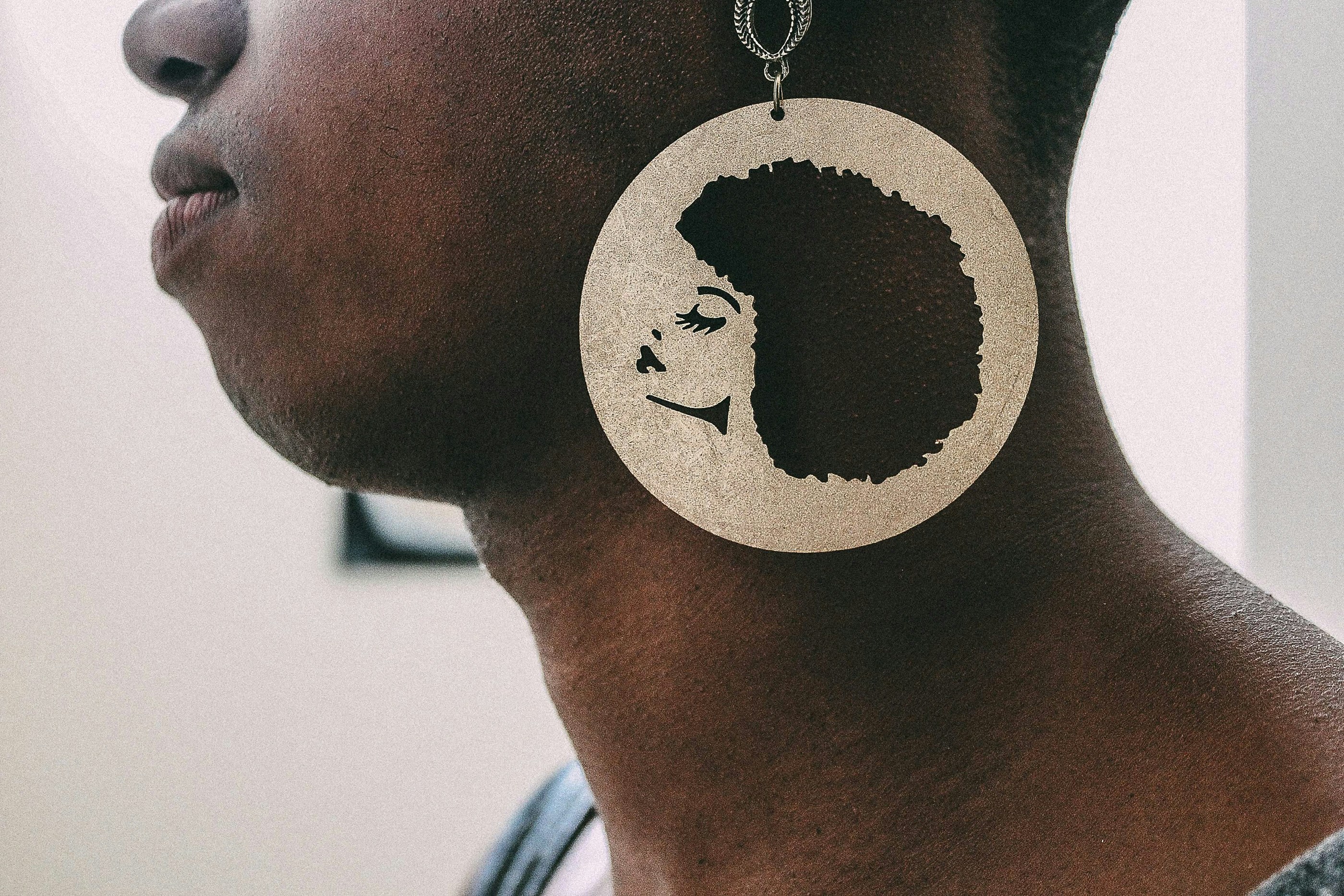 person wearing silver-colored earring