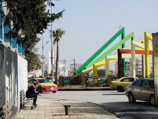 person sitting on bench beside road in Irbid Jordan