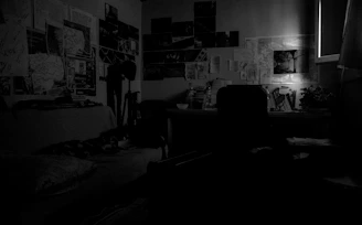 A cozy writer's desk with scattered manuscripts, a vintage camera, and soft natural light filtering through a window.