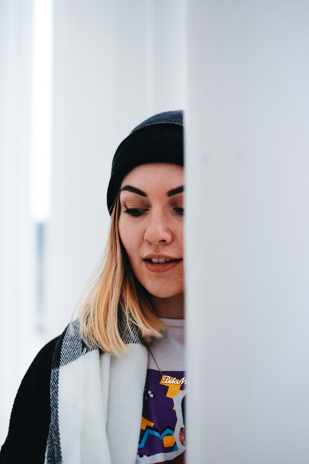 woman behind a white wall