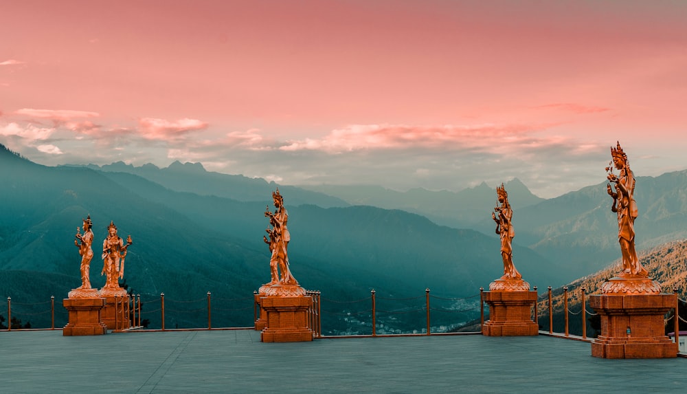 five human statues during daytime