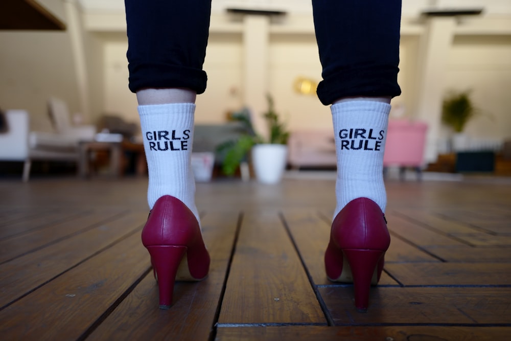 woman in pink pumps standing inside room