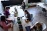 a group of people sitting around a wooden table