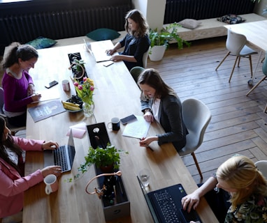 a group of people sitting around a wooden table