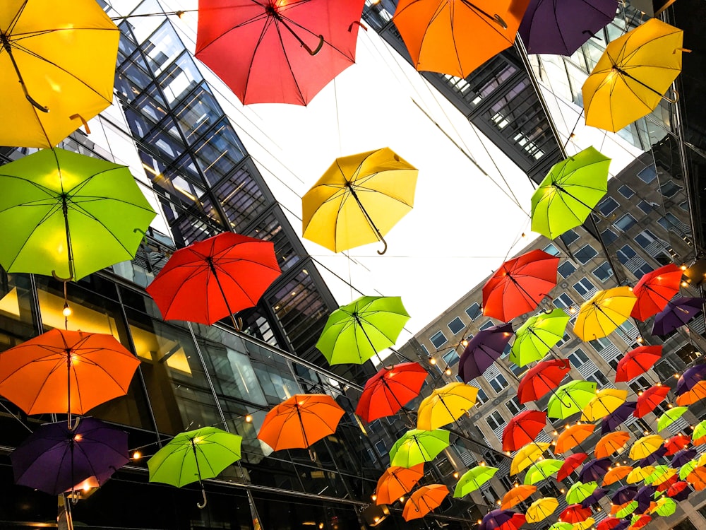 assorted-color umbrella lot near buildings