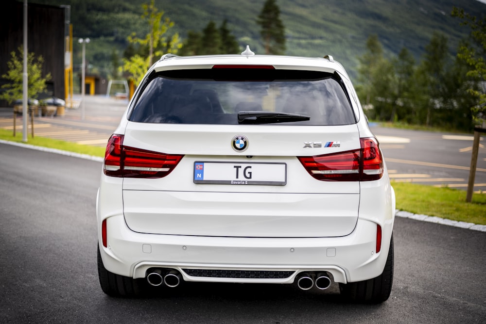 white hatchback car beside road