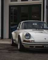 A beautifully restored vintage Porsche 911 in a garage.