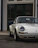 A sleek restored classic Porsche parked elegantly in a sunlit Mallorca garage with gold accents.