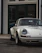 A sleek restored classic Porsche parked elegantly in a sunlit Mallorca garage with gold accents.
