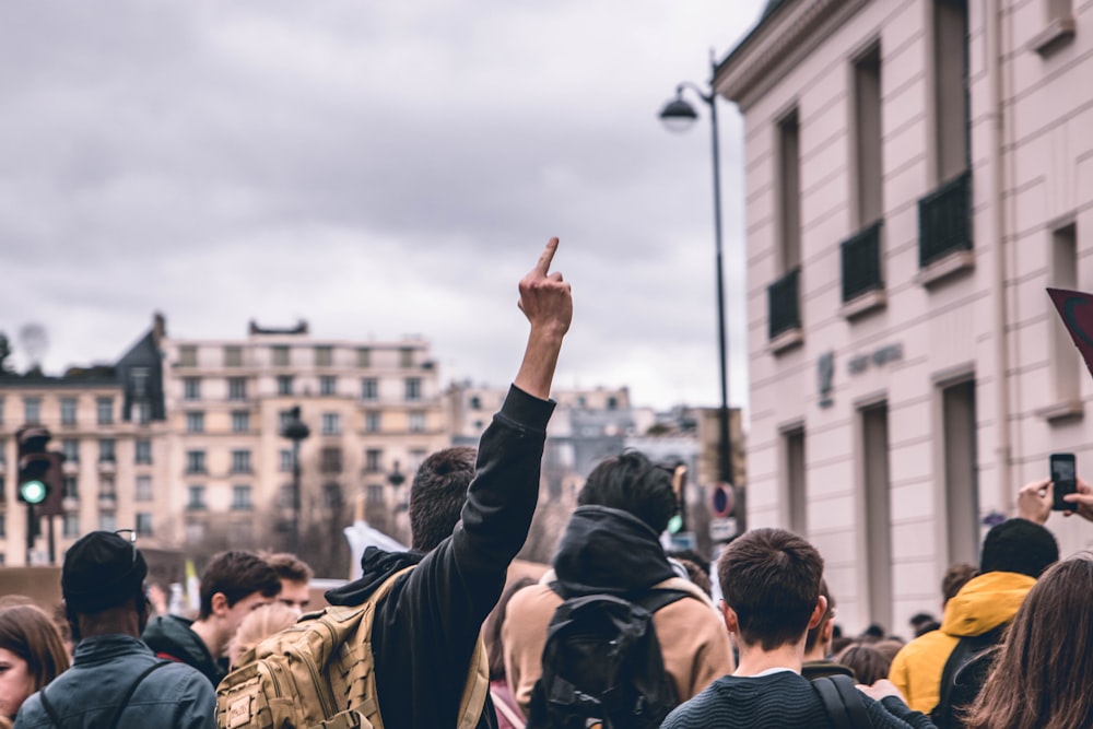 people gathering in front of white concrete building during daytime