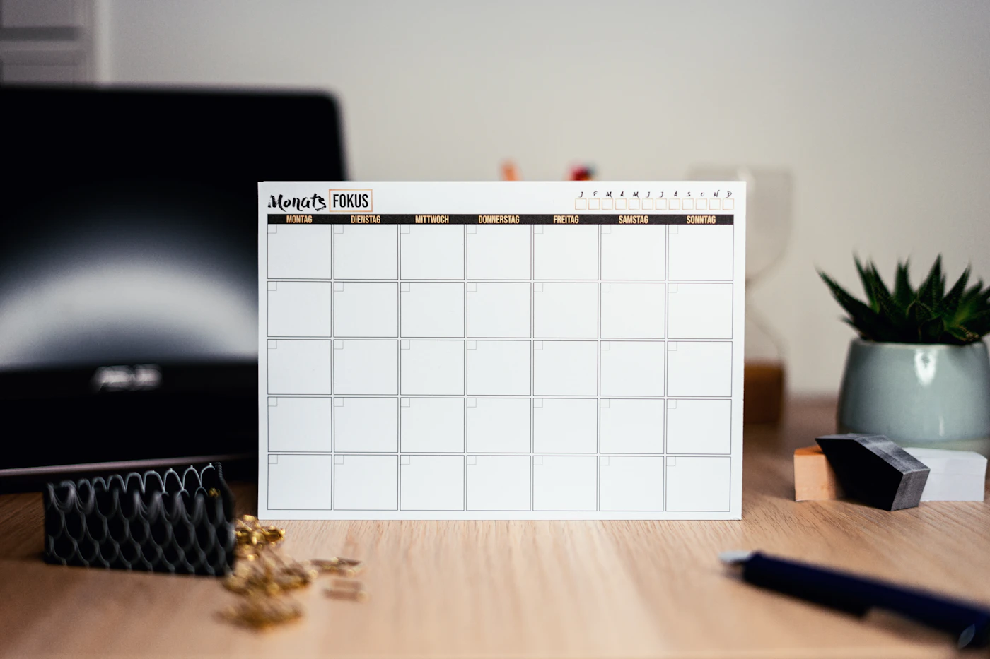 A blank monthly calendar on a desk