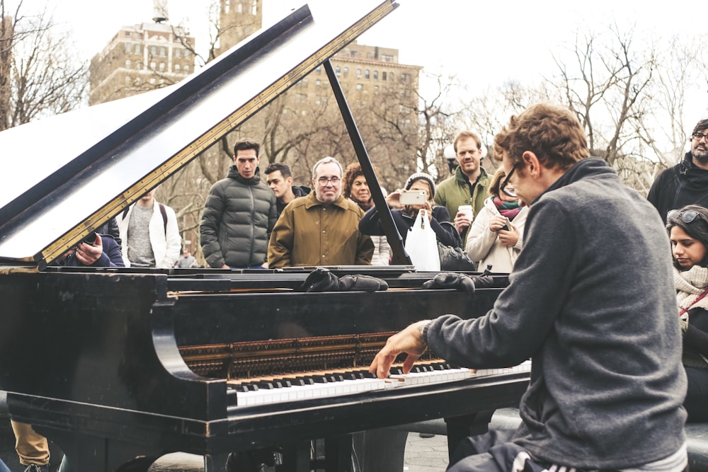 man playing piano in public place