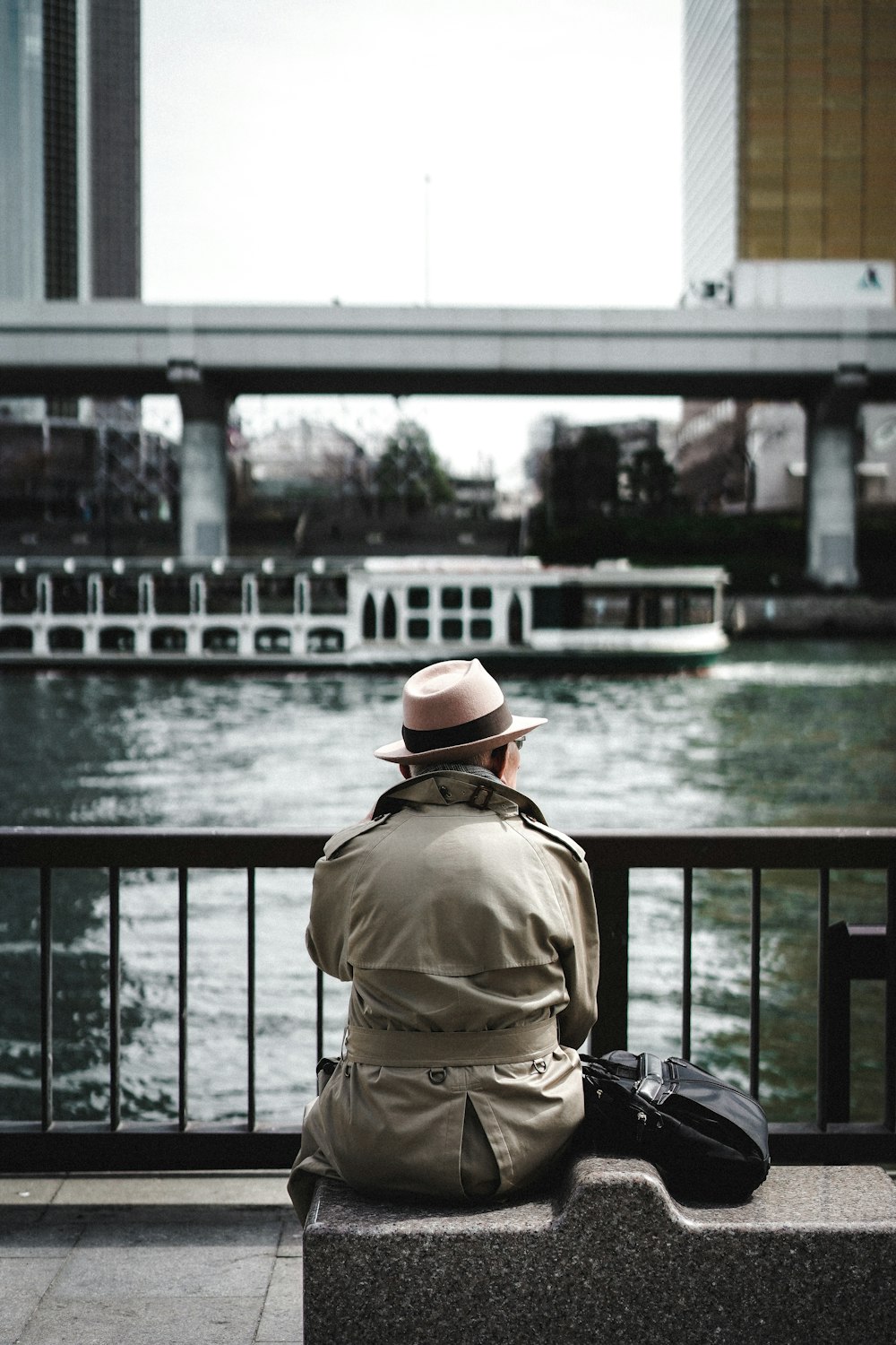 person sitting down on concrete bench