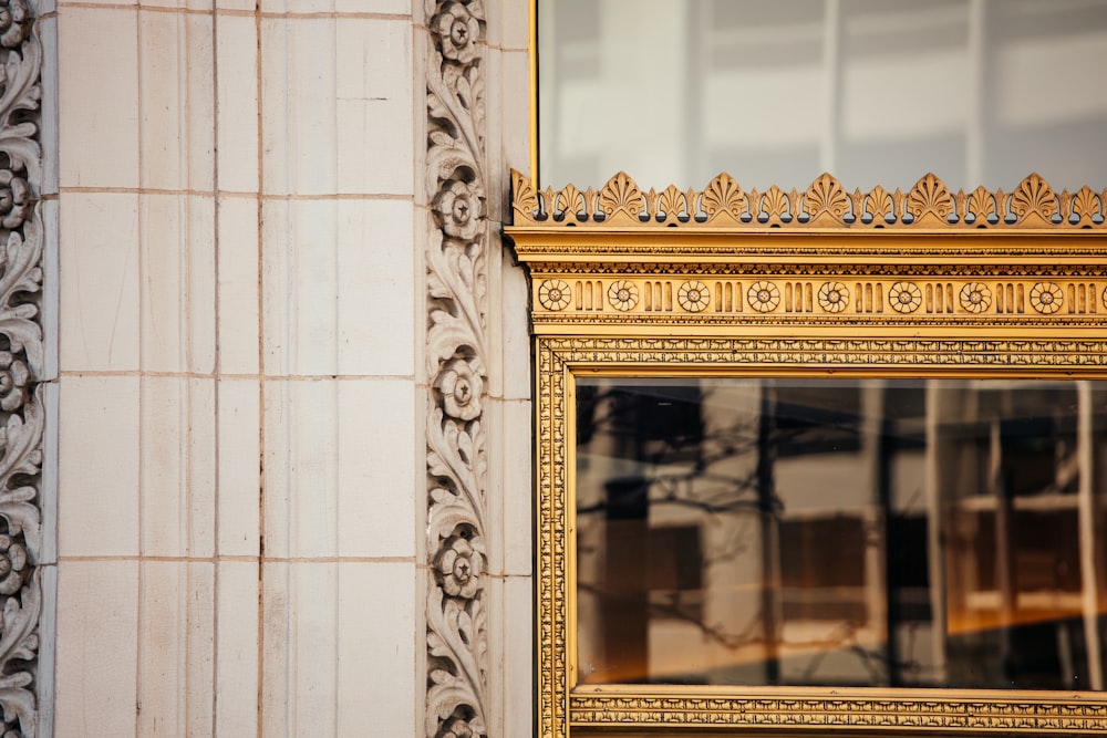 a close up of a gold frame on a building