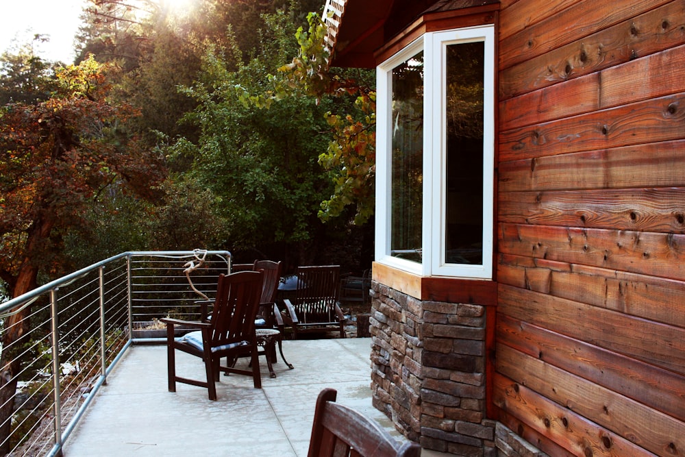 two brown armchairs in front of housue