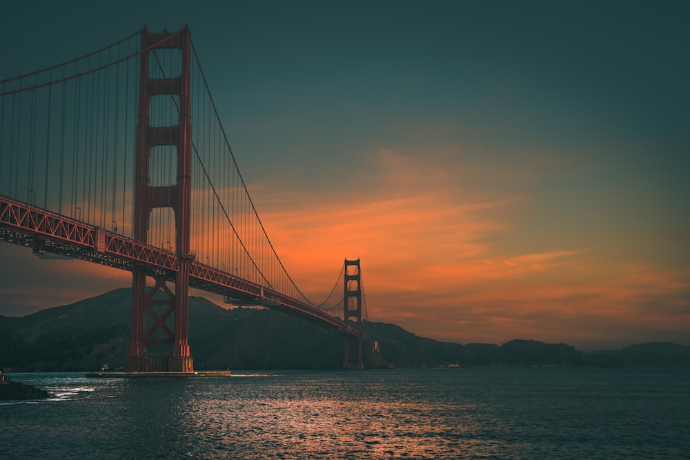 the golden gate bridge at sunset as seen from the water