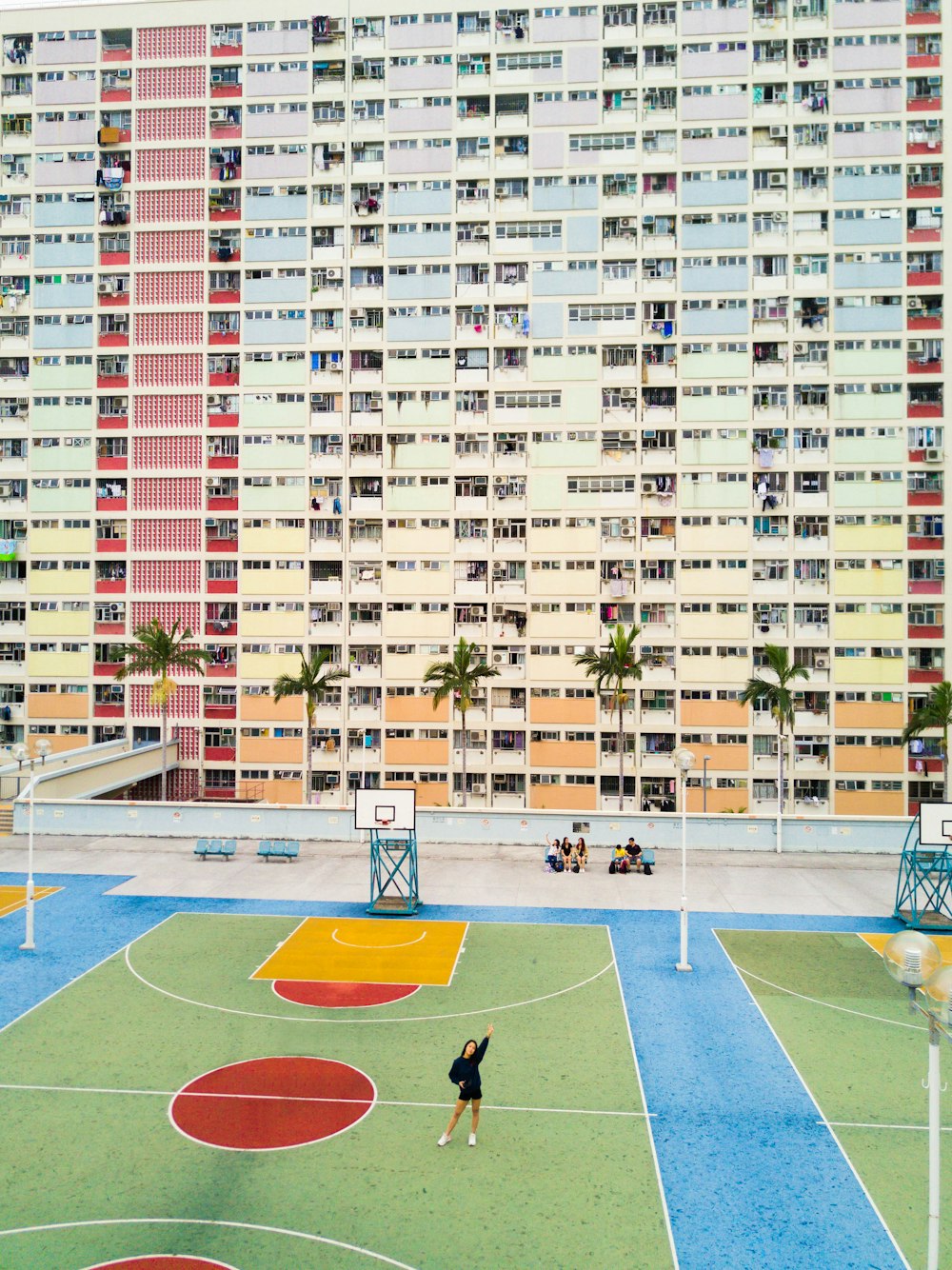 woman standing on basketball court near hote