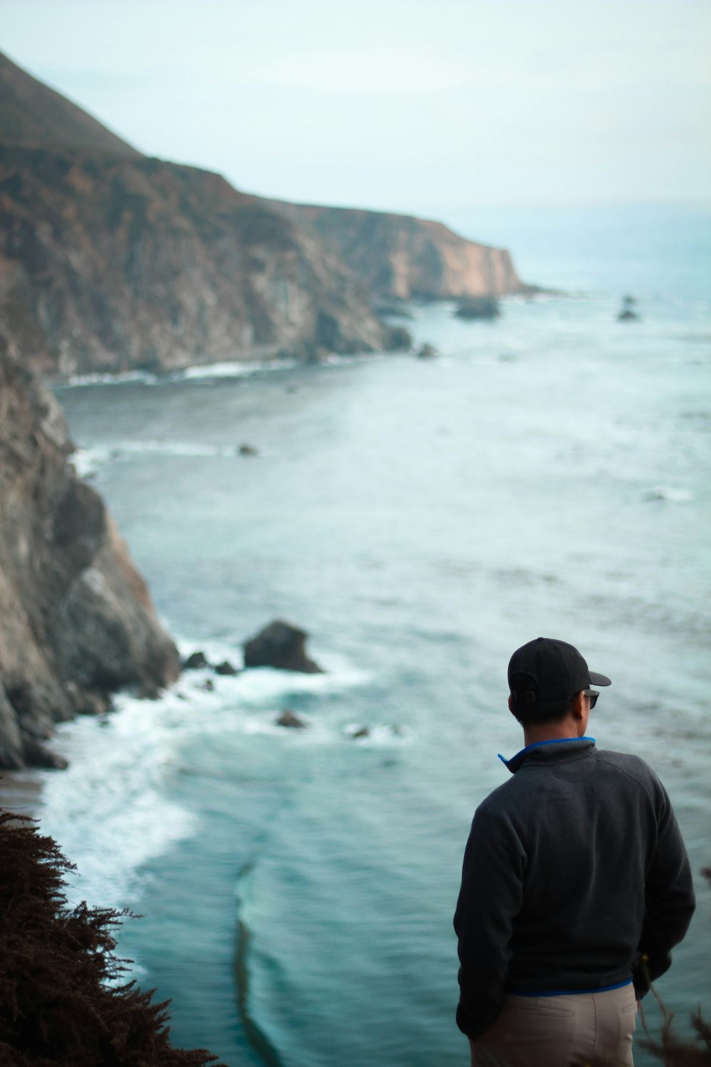 man standing in front of body of water