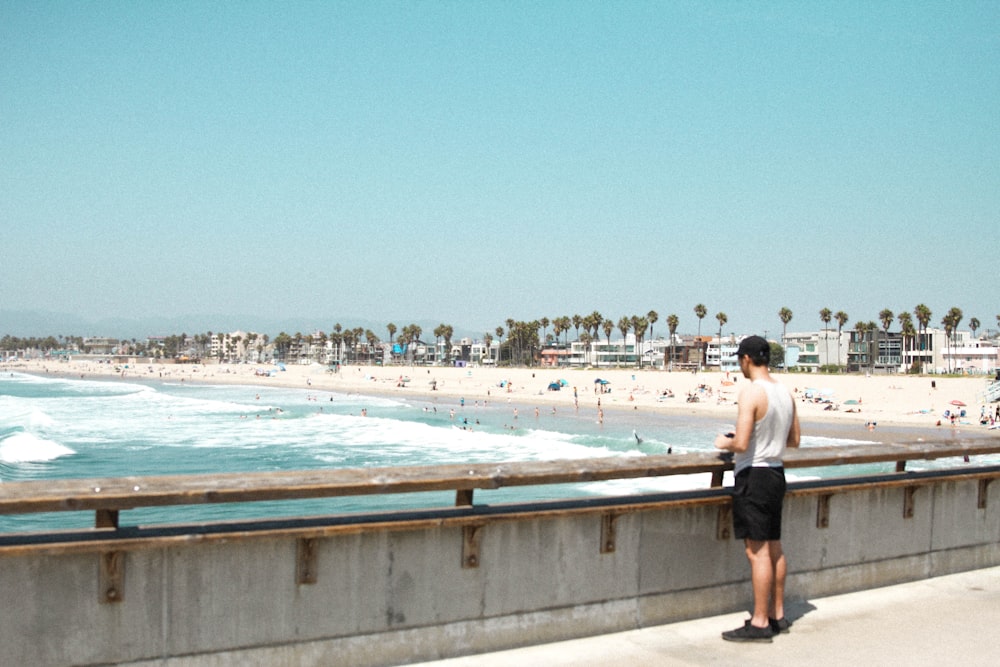 man standing facing sea