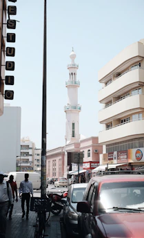 A busy city street in Oman showcasing cars available for lease and rental.