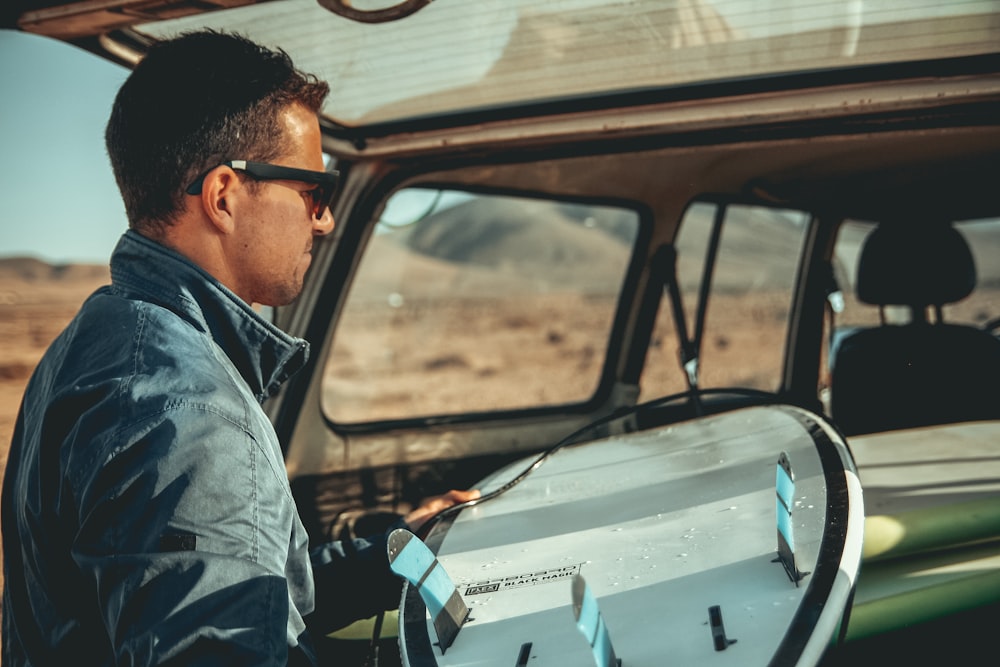 man standing in back of vehicle