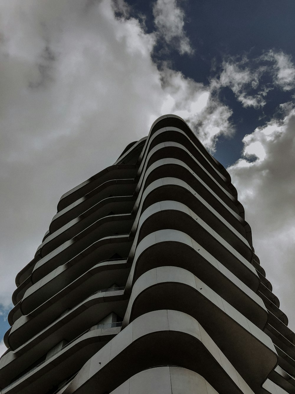 white high-rise building under white and blue sky