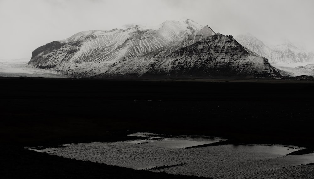 grayscale photography of snow-capped mountain