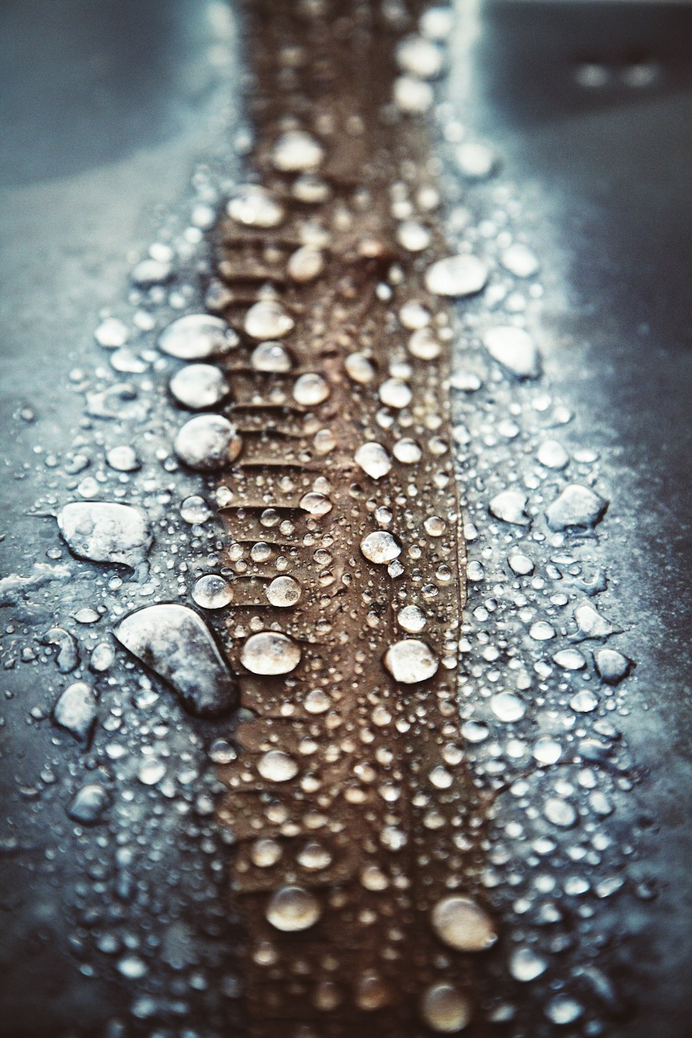 a close up of water droplets on a metal surface