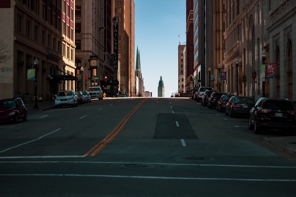 vehicles parked beside high-rise buildings