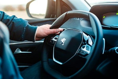 Trucker dating app conversation — driver's hand on the wheel before a rest break