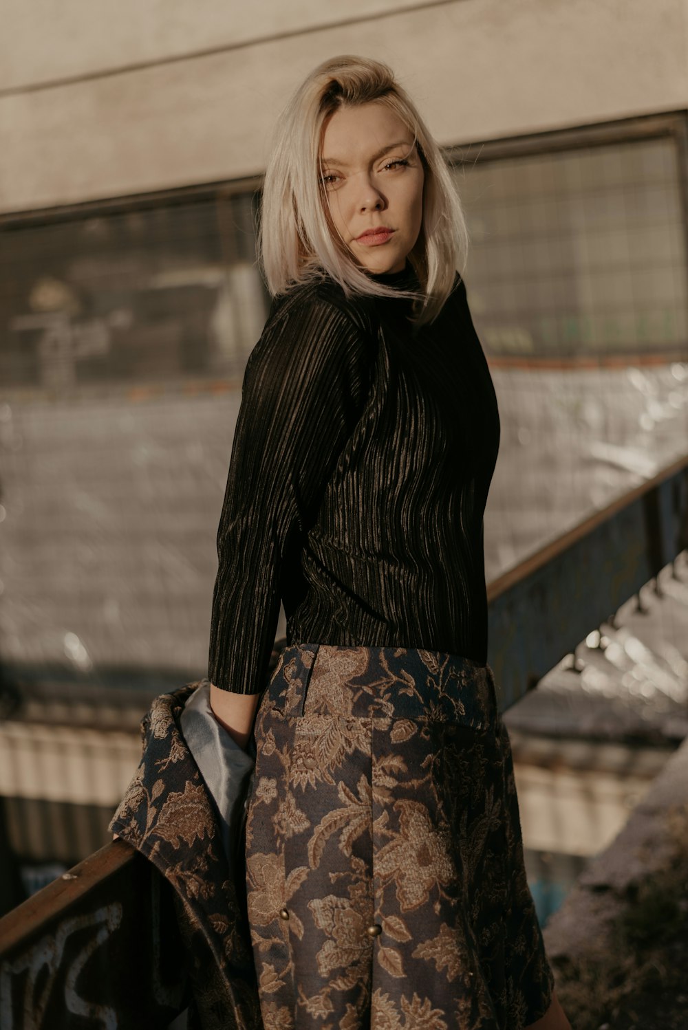 woman leaning on wooden rail during daytime