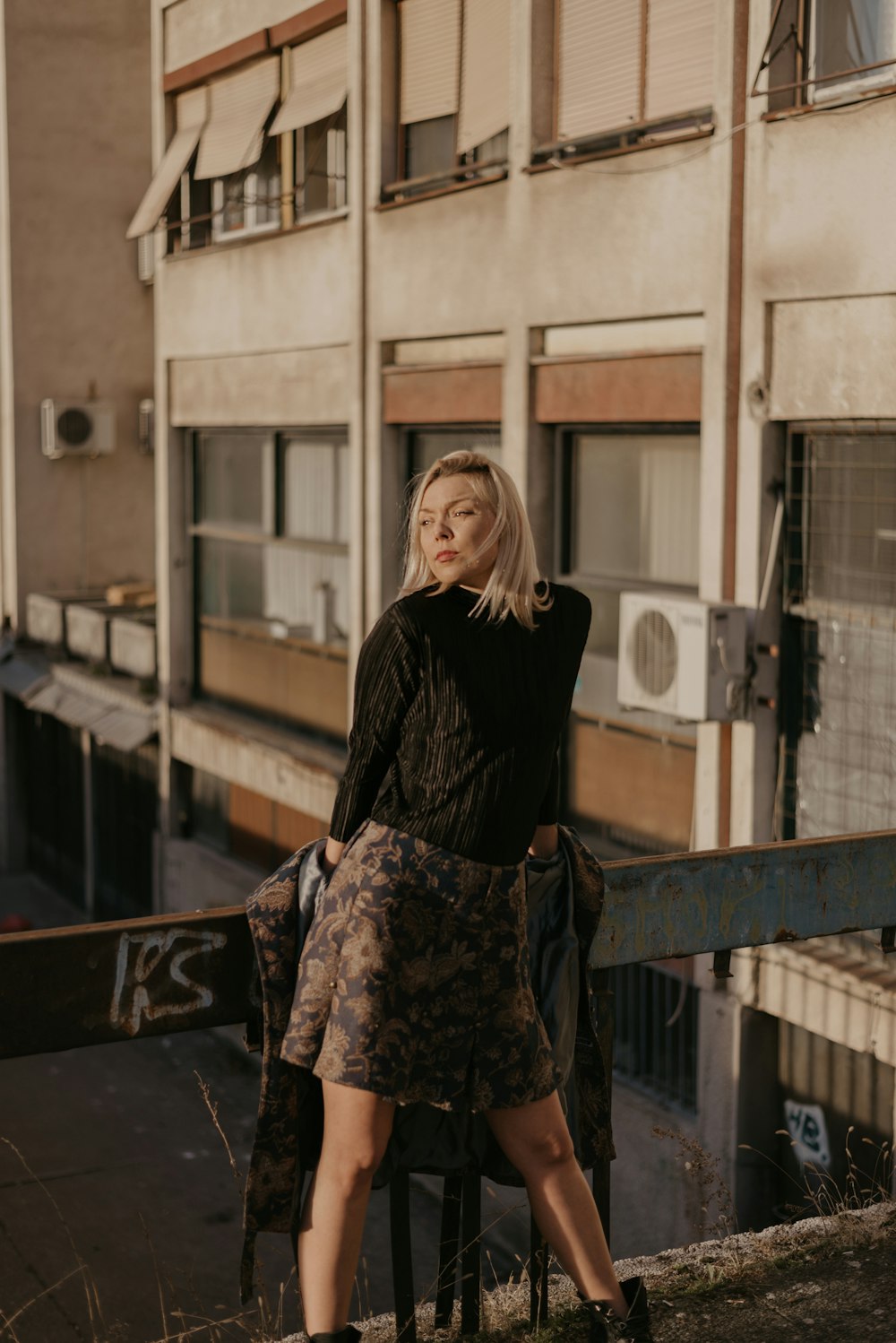 blonde woman stands in porch