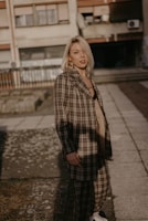 woman wearing brown and white plaid coat during daytime