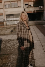 woman wearing brown and white plaid coat during daytime