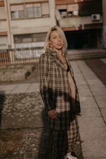 woman wearing brown and white plaid coat during daytime