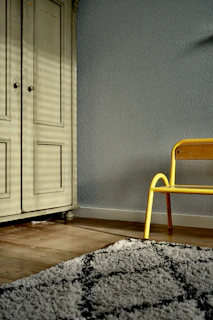 brown wooden wardrobe near grey wall