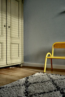 brown wooden wardrobe near grey wall