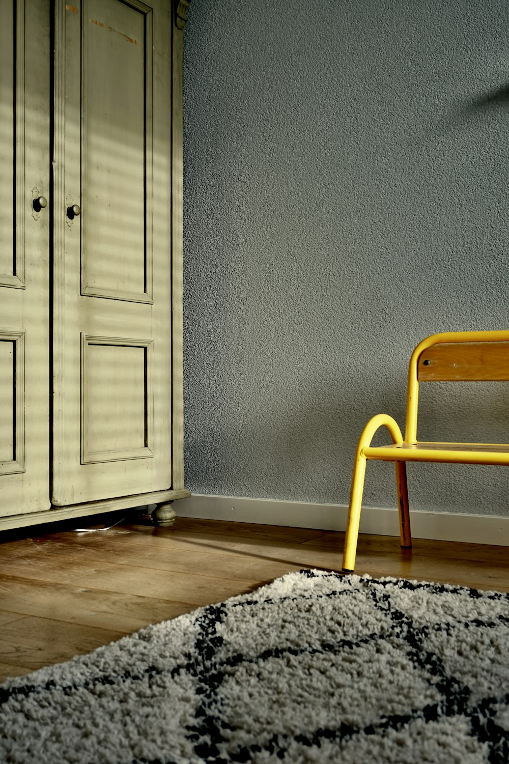 brown wooden wardrobe near grey wall