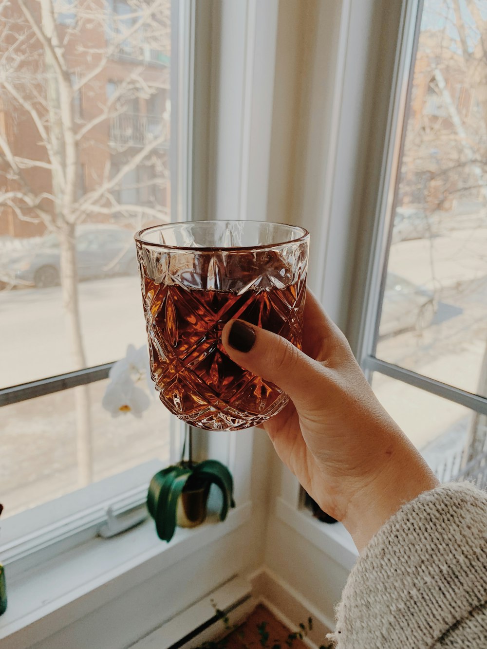 clear cut drinking glass field with brown liquid