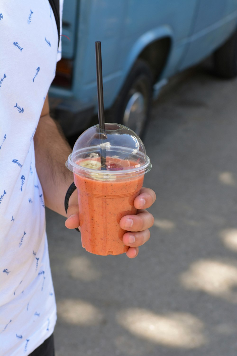 person holding cup of drink during daytime