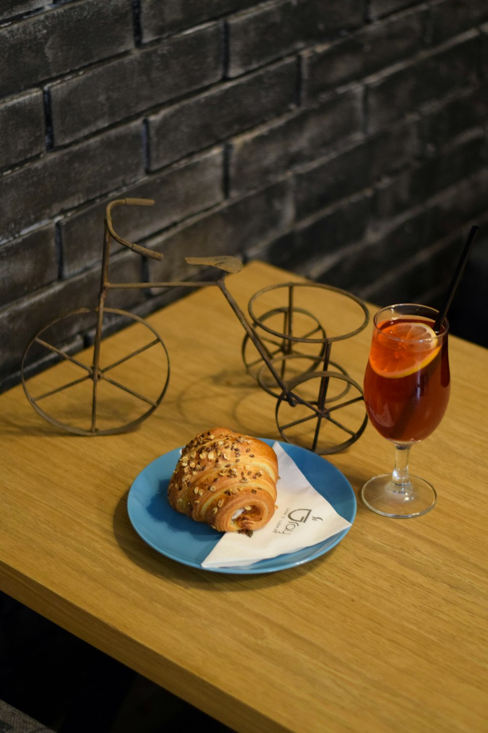 pastry bread on blue plate beside lemon juice