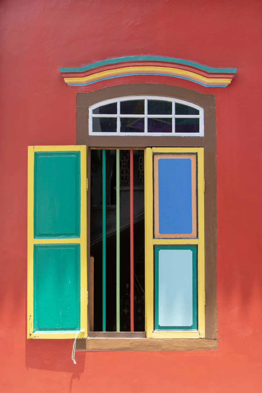 colorful window on red wall