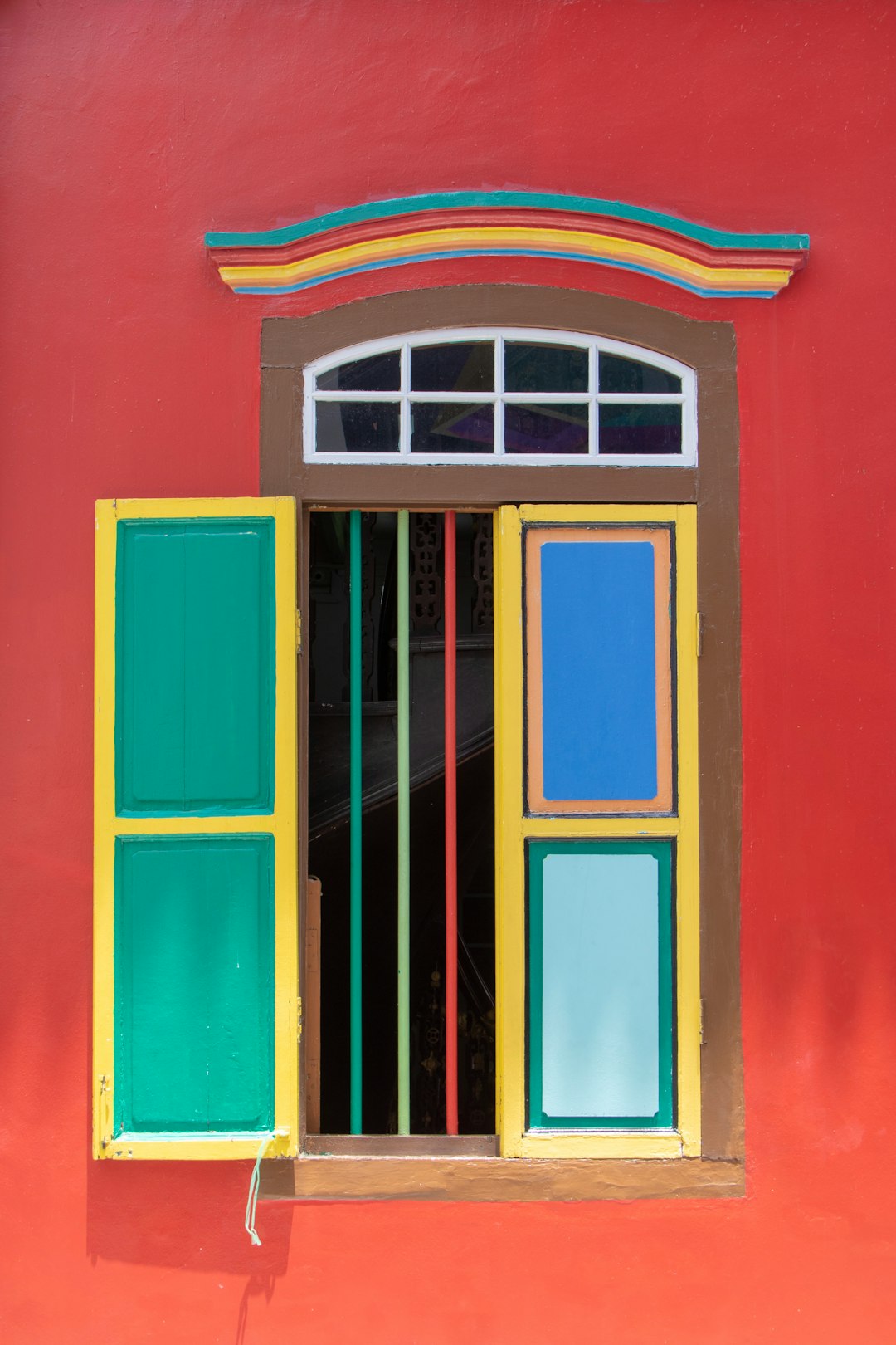 colorful window on red wall