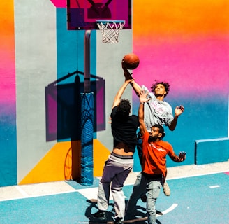 three people playing basketball
