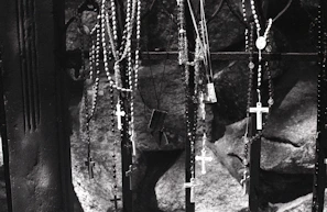 Religious gift items including rosaries and prayer cards, styled with a dark, somber tone reflecting the Death Korps theme.