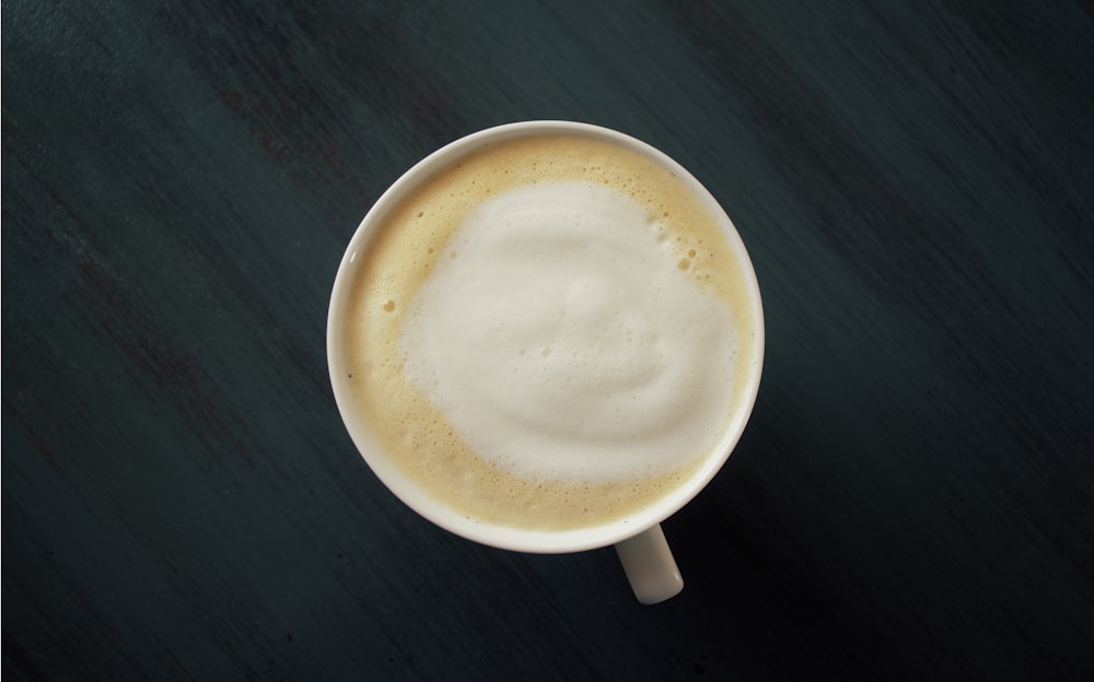 white ceramic mug on black surface