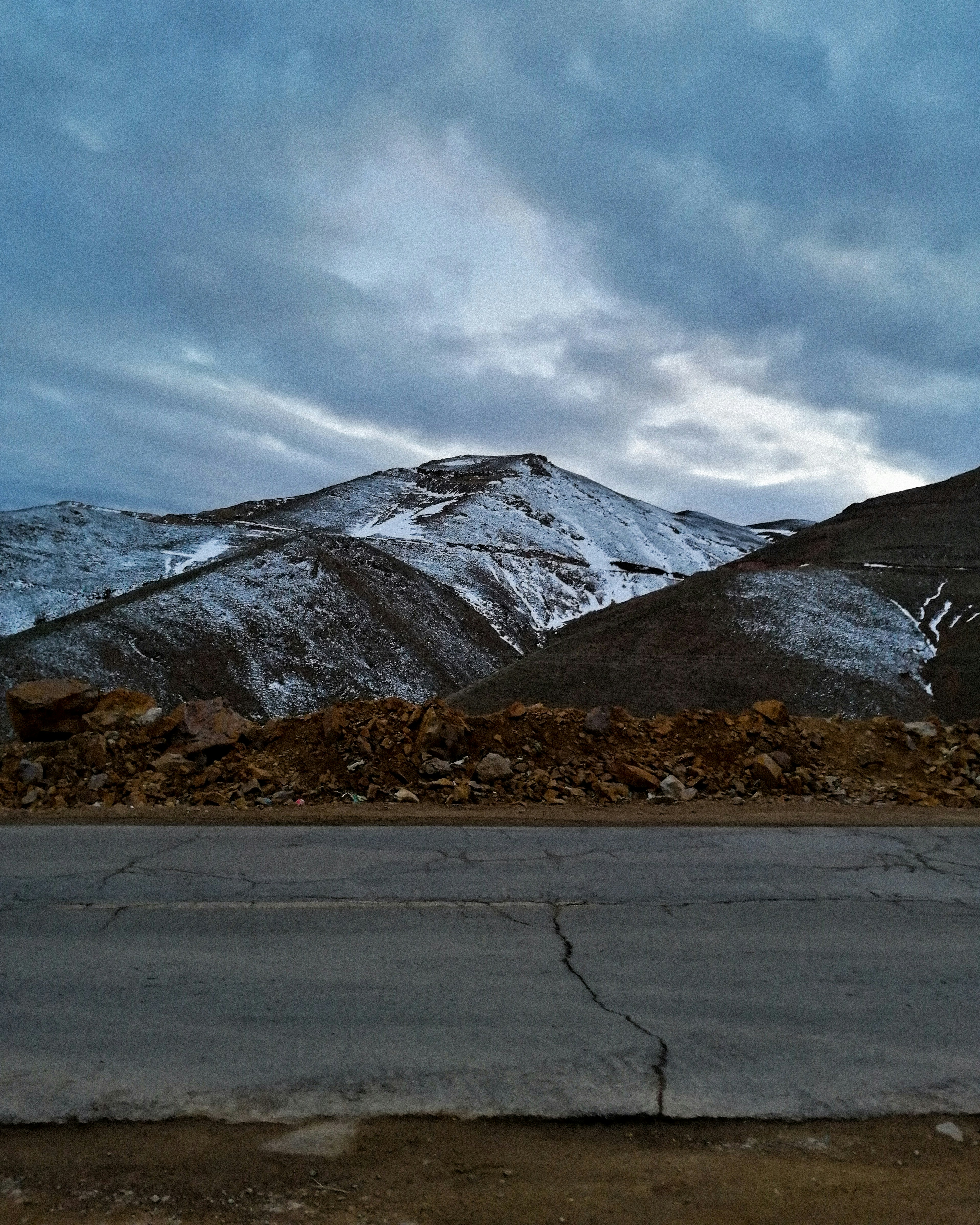 snow covered mountain under cloudy sky during daytime