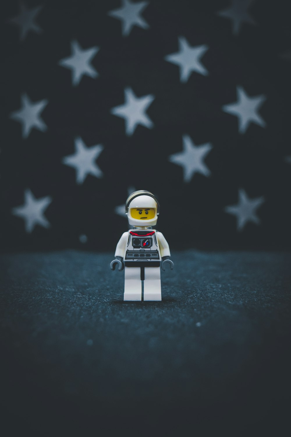 Lego astronaut on gray surface